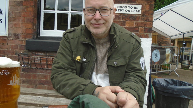 A view of fresh eggs and bacon cooking over a small, contained campfire