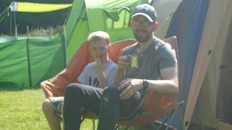 Outside tent enjoying a cup of char.